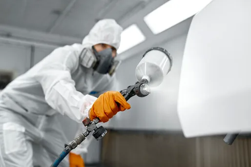 Spraying a smooth finish on doors in the shop