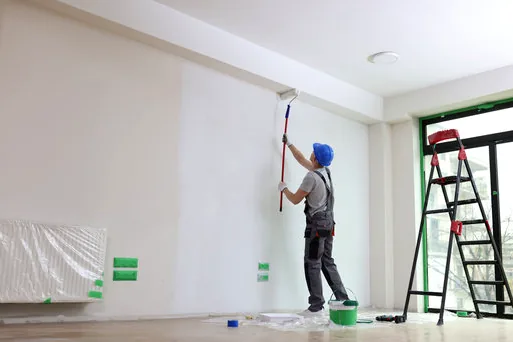 Painter rolling a clean white wall in a Newport Center office